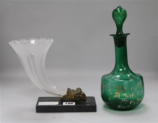 A glass cornucopia on stand and a gilt decanter